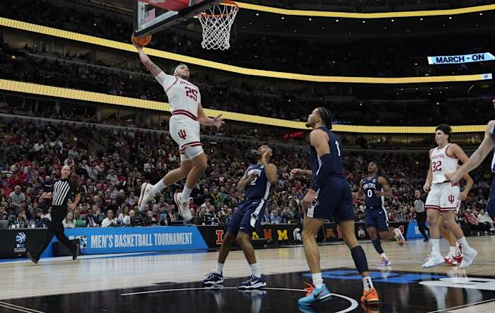Race Thompson (25) goes up for a dunk against Penn State Nittany Lions guard Seth Lundy (1) during the first half at United Center.
